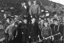 043: Group of Red Island children. (1962) [courtesy of Sadie (Norman) Kerrivan]  l-r front, unidentified, Phonse Mulrooney (checked shirt under jacket),unidentified,  unidentified, Leonard Mulrooney (face half shaded), Calvin Kerrivan (brush haircut),  Jim Mulrooney (center front), Leonard Barry (checked shirt with jacket), Raymond  Mulrooney (light hair, out front), Pius Mulrooney (behind, head tilted), unidentified,  Bill Mulrooney (behind, large plaid), l-r back, unidentified (hidden), unidentified,  Clarence Norman (blonde), Berkley Mulrooney (small-check jacket).